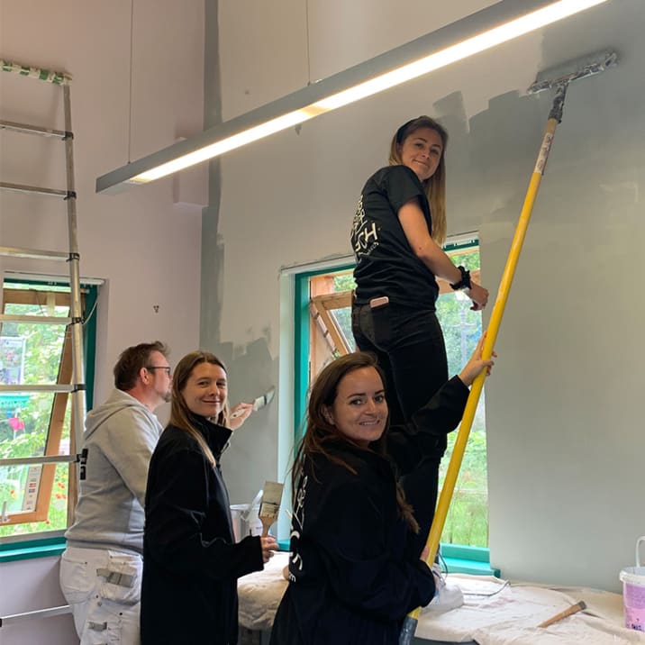 Members of the Patch team decorating a room